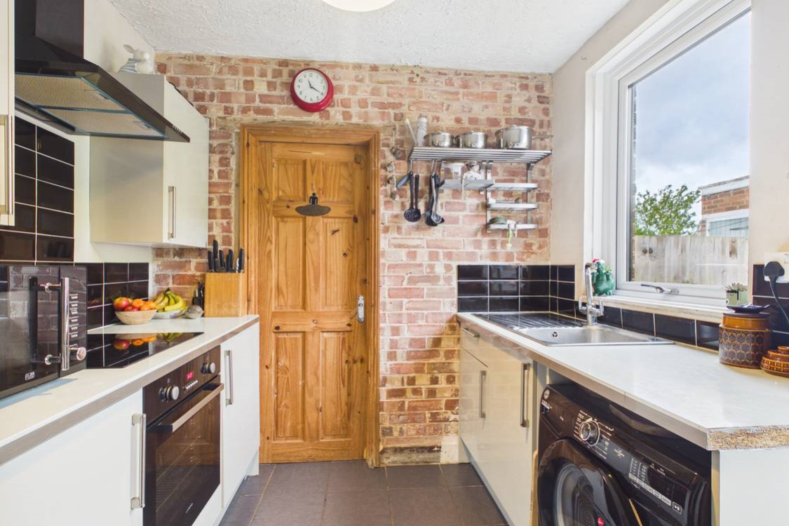 The exposed brick work is stunning in this kitchen