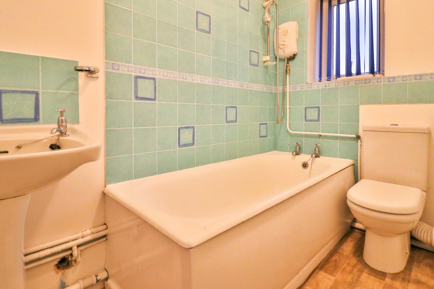 Bathroom with over bath shower