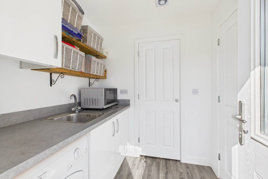 A view from the back door showing a cupboard housing the boiler and water tank meaning this space dries clothes quickly when its too wet for outside