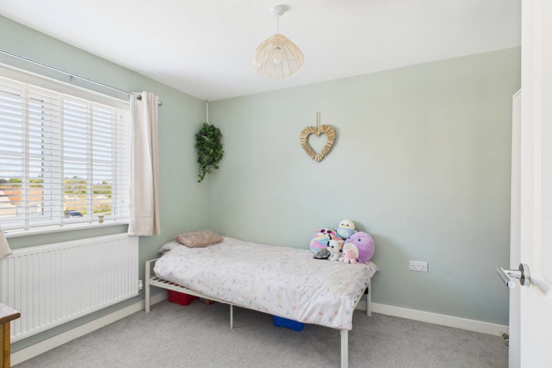 Painted in gorgeous sage green this freshly decorated room comfortably fits a double bed and furniture
