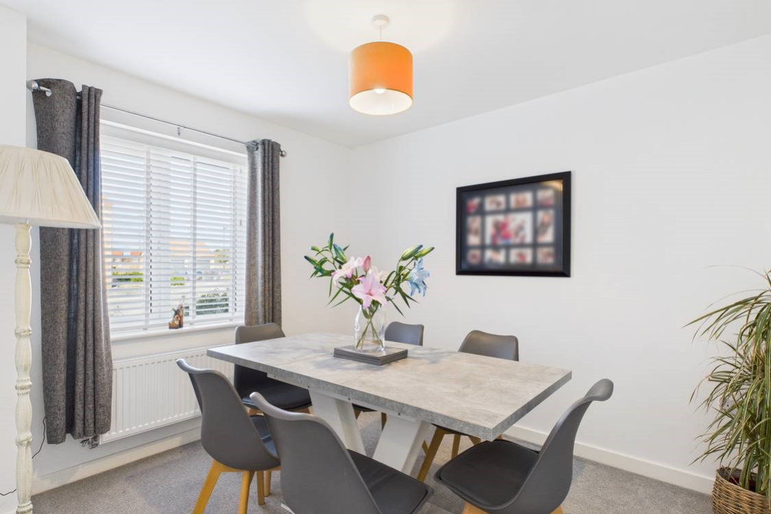 Spacious and neutrally decorated this dining room is perfect for family dinners or weekend entertaining